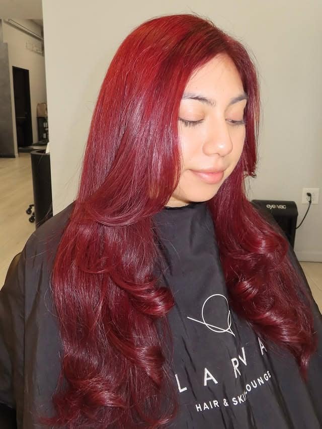 9. Crimson Red Layers with Face-Framing Movement - Red Hair Color