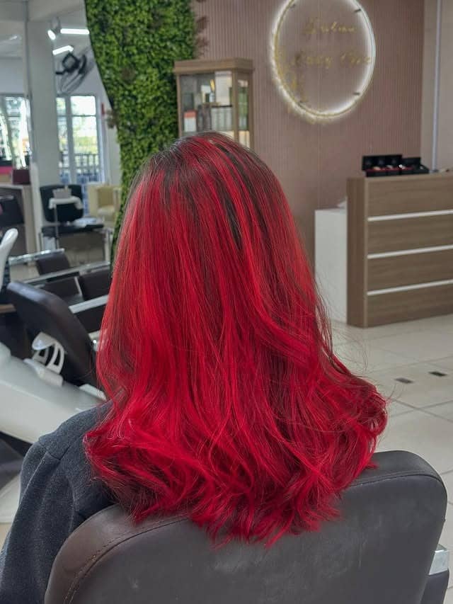 11. Vivid Red Shoulder-Length Waves - Red Hair Color