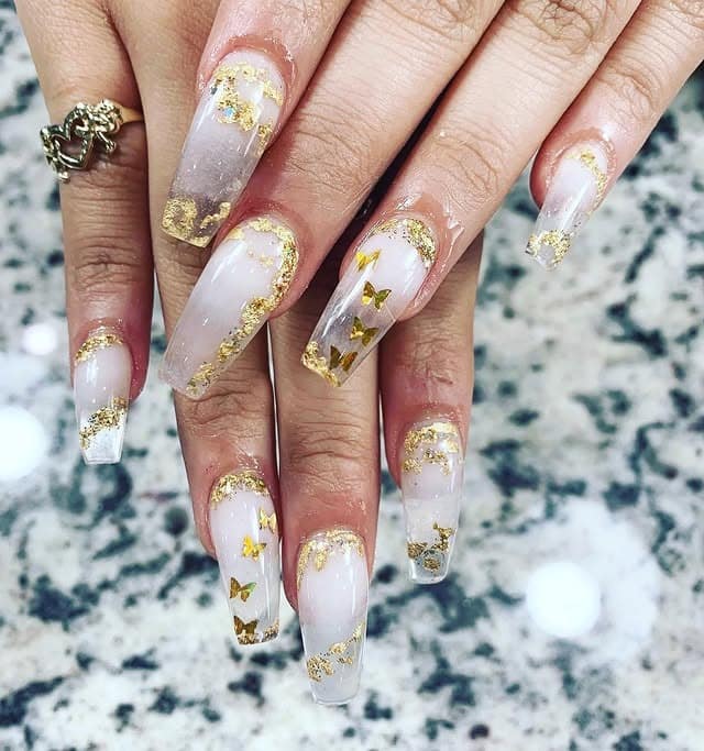9. Milky White Coffin Nails with Gold Foil and Stars - gold foil nail ideas