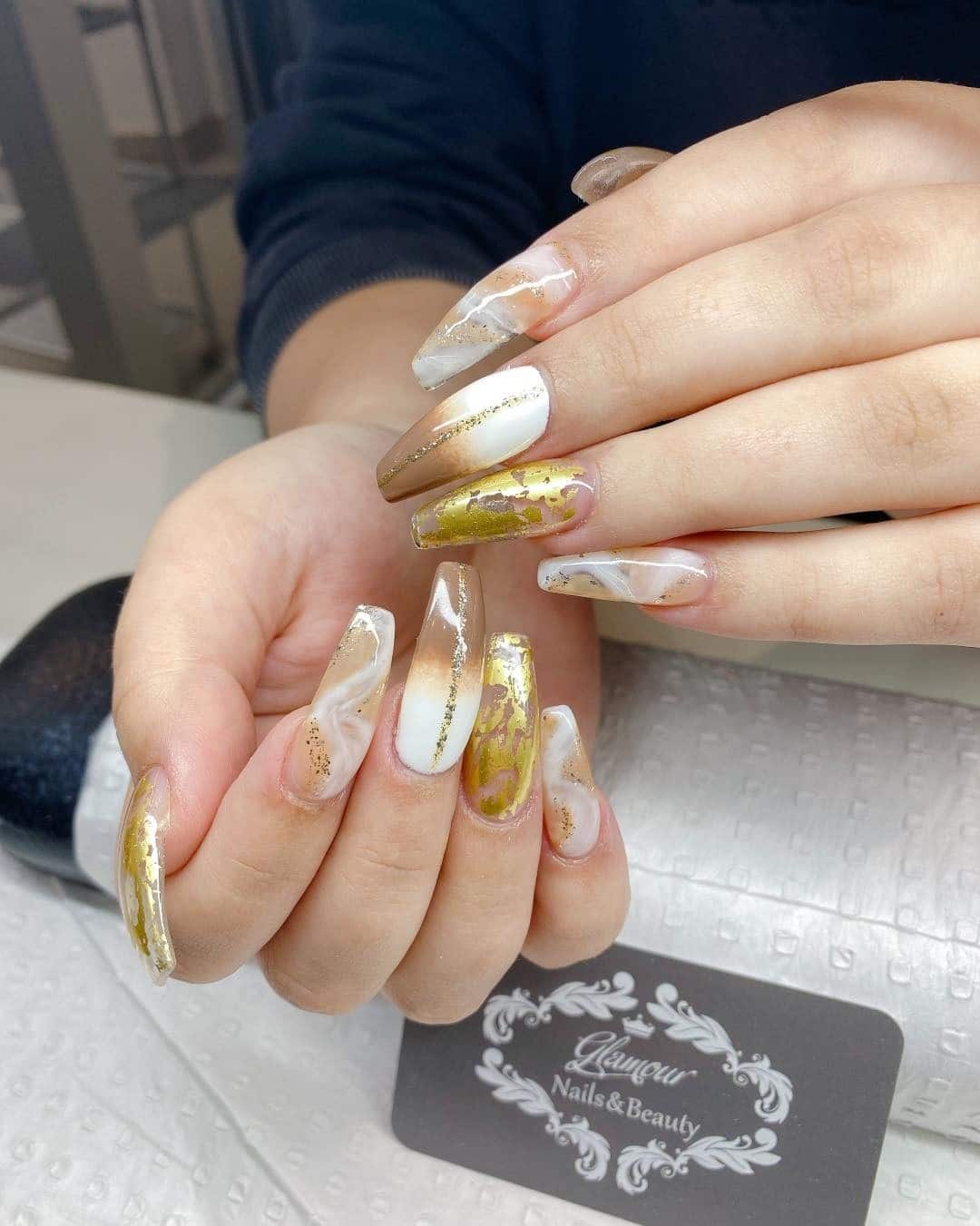 11. Neutral Marble Almond Nails with Gold Foil Accents - gold foil nail ideas