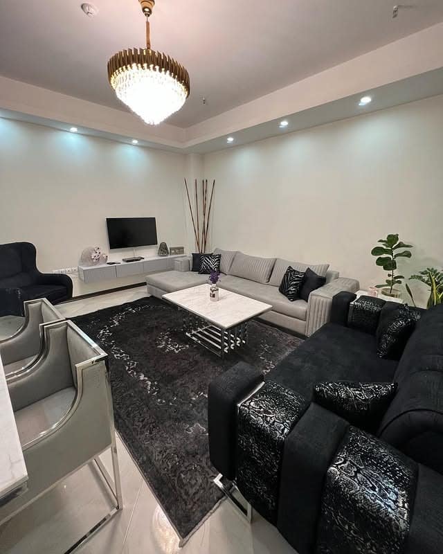 6. Luxury Living Room with Black and Silver Statement Carpet - living room carpet ideas