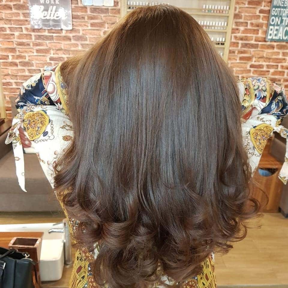 6. Warm Brunette Long Layers with Curled Ends - Long Layered Hairstyles