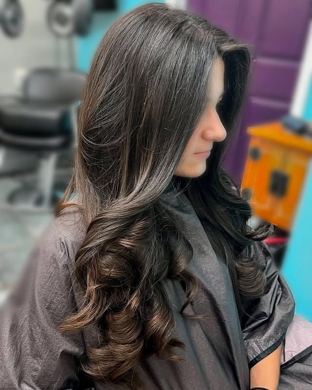 10. Dark Brown Long Layers with Polished Waves - Long Layered Hairstyles