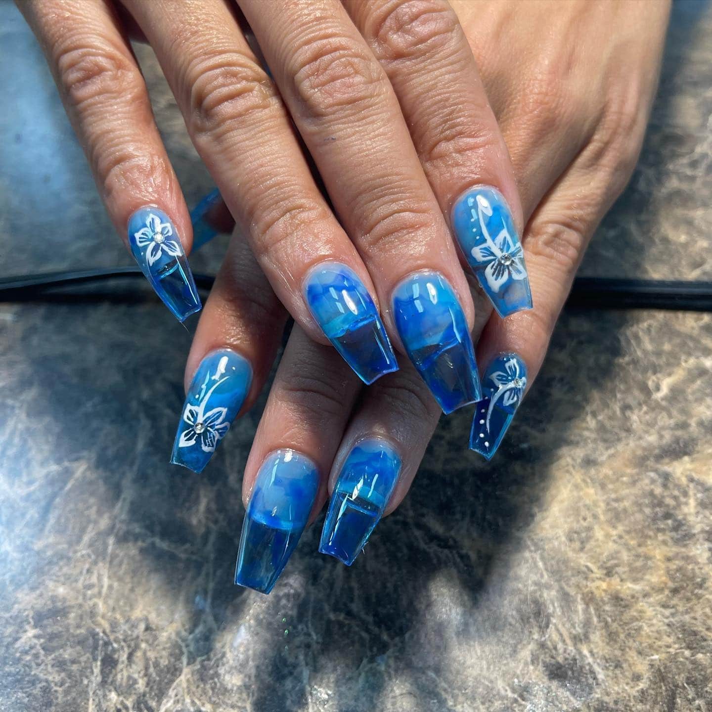 4. Ocean Blue Floral Coffin Nails - hawaiian flower nail ideas