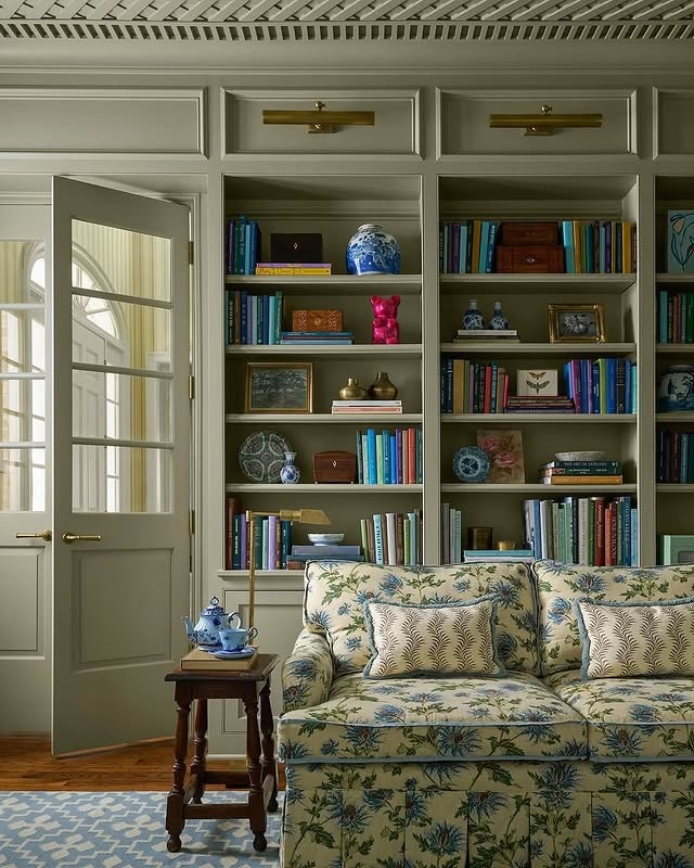 2. Traditional Library Shelving in Soft Sage and Brass - living room shelf ideas