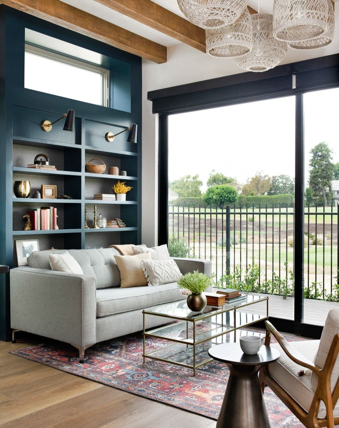 3. Moody Blue Shelving with Modern Brass Details - living room shelf ideas