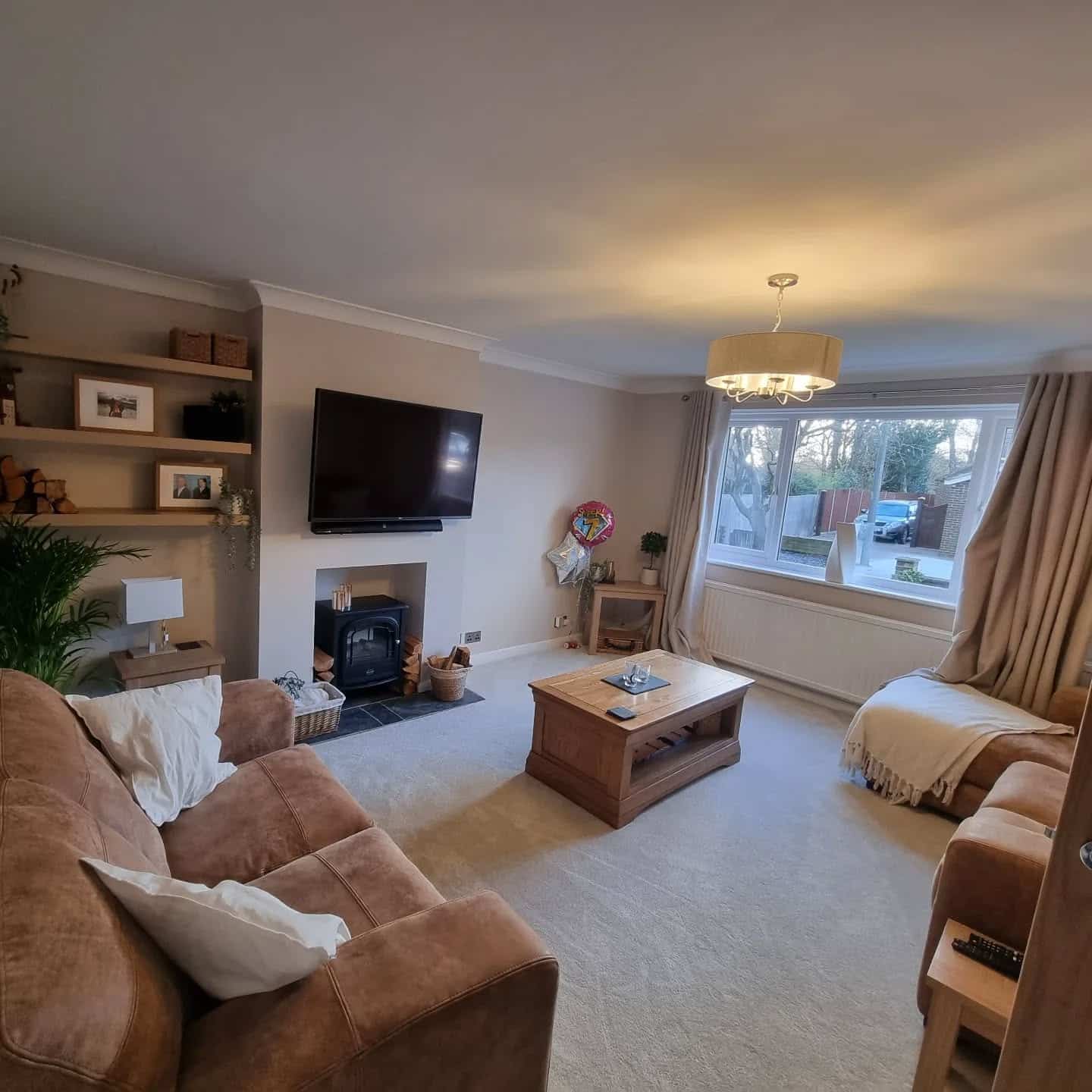 4. Warm Neutral Shelves Framing a Cozy Fireplace - living room shelf ideas