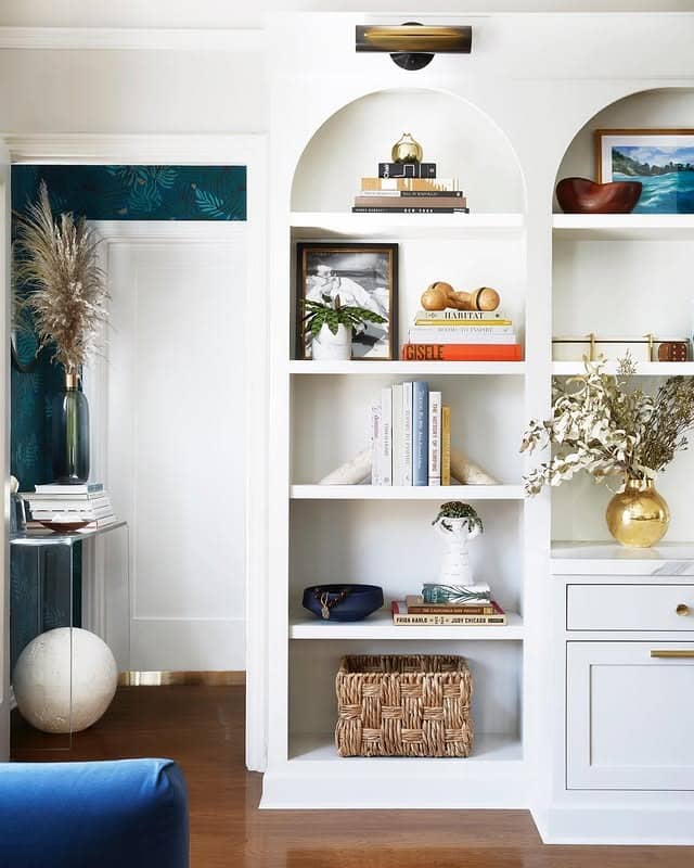 12. Arched Built-In Shelves in Cream and Brass - living room shelf ideas