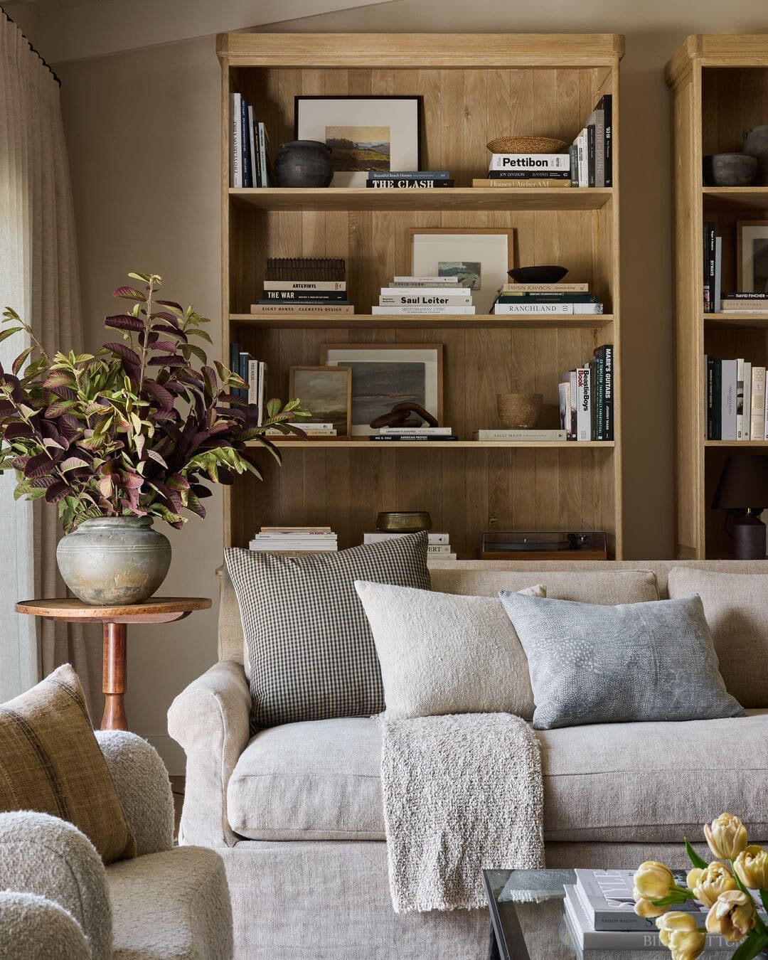 21. Layered Wood Shelving in Warm Oak and Soft Neutrals - living room shelf ideas
