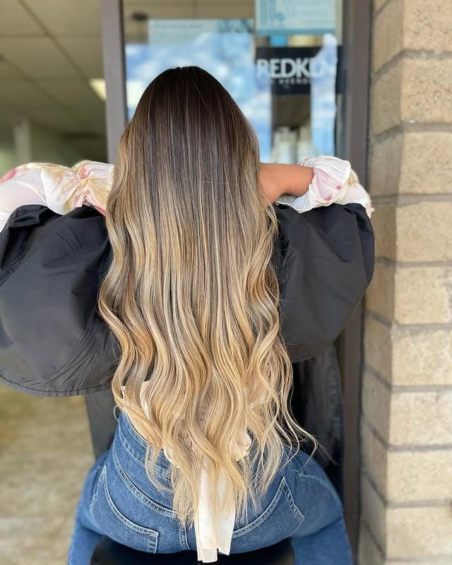 12. Rooted Blonde Balayage with Long Cascading Waves - Blonde Balayage Hair Color