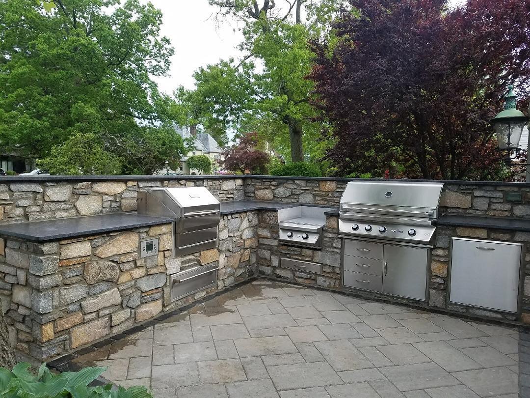 9. Classic Stone Wall Kitchen in Gray and Stainless Steel - rustic outdoor kitchen ideas