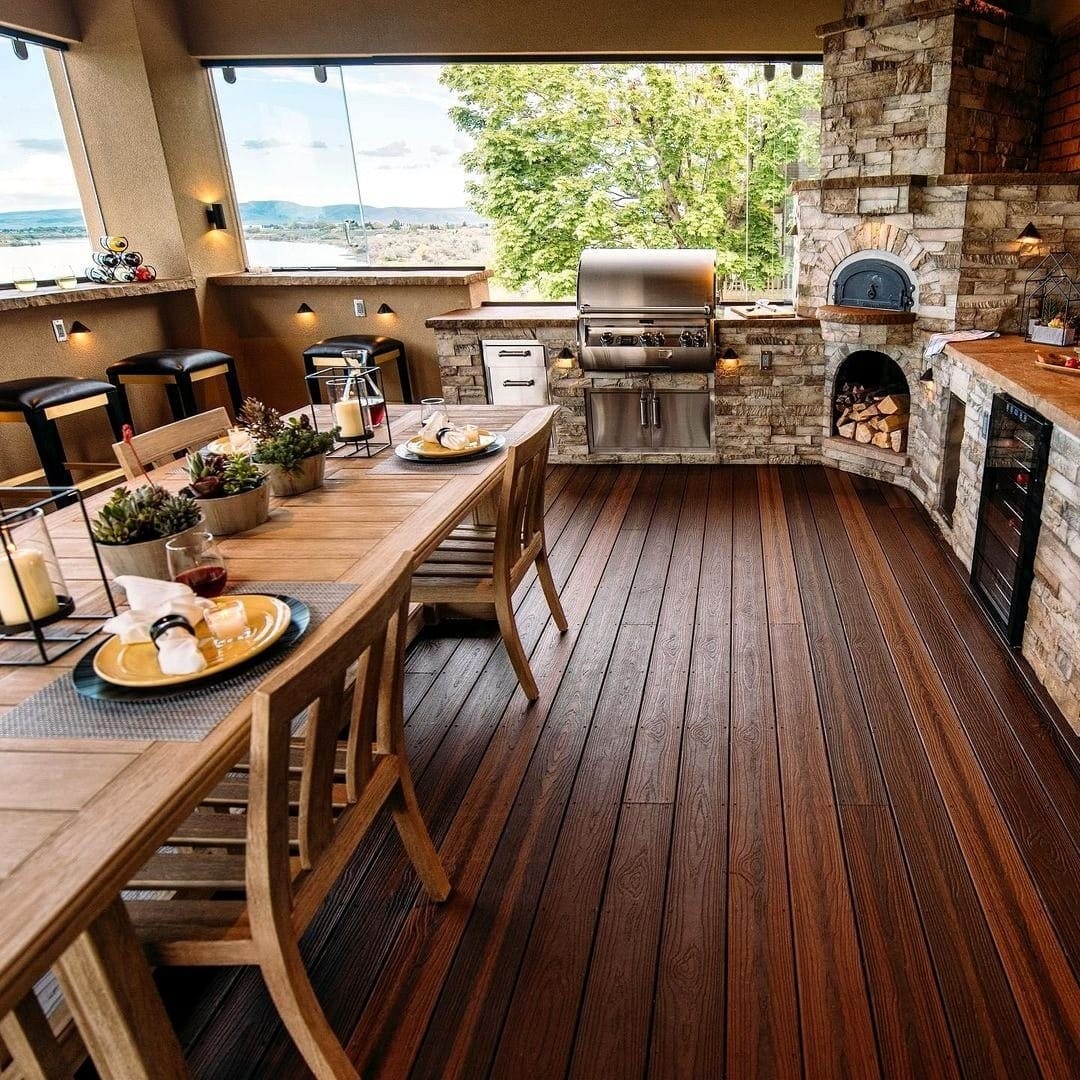12. Covered Stone Patio Kitchen in Taupe, Wood, and Charcoal - rustic outdoor kitchen ideas