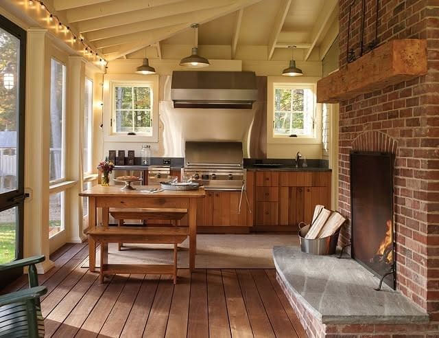 15. Enclosed Porch Kitchen with Cream, Wood, and Brick - rustic outdoor kitchen ideas