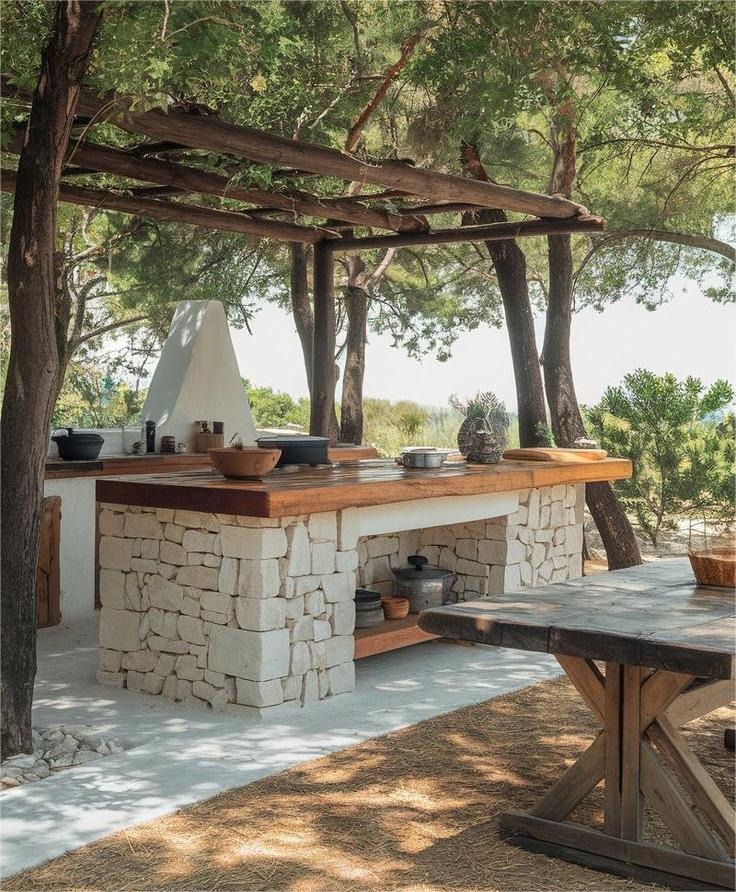 20. Mediterranean-Inspired Outdoor Kitchen in White Stone and Walnut - rustic outdoor kitchen ideas