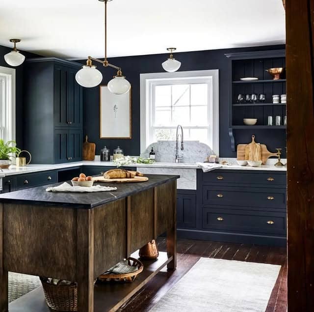 7. Inky Navy Kitchen with Classic Millwork - moody kitchen ideas