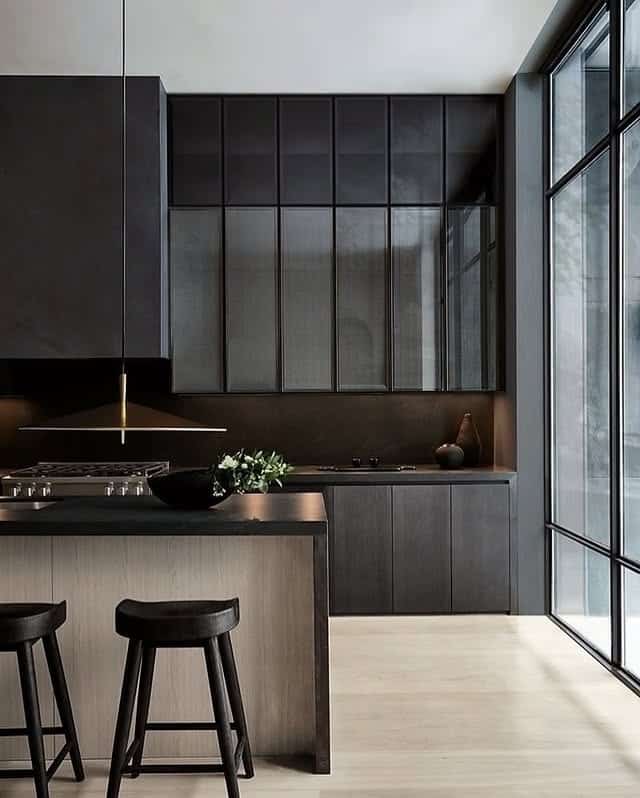 9. Modern Black Kitchen with Soft Wood Undertones - moody kitchen ideas