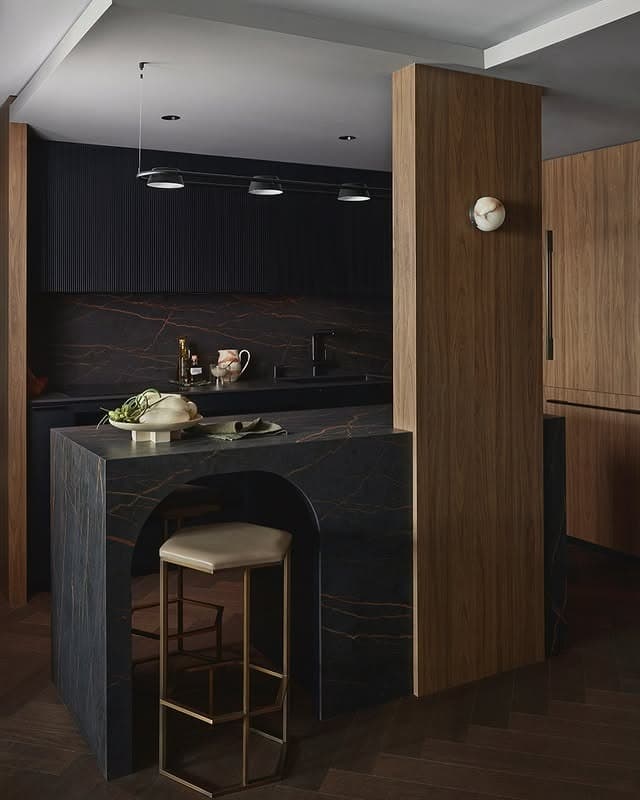 11. Sculptural Black Kitchen with Dark Stone Detailing - moody kitchen ideas