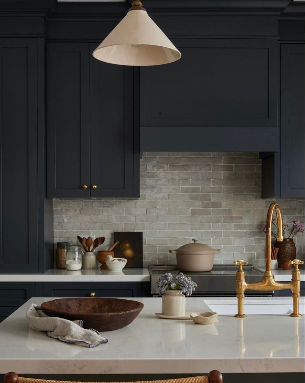 14. Deep Navy Kitchen with Stone and Brass Accents - moody kitchen ideas