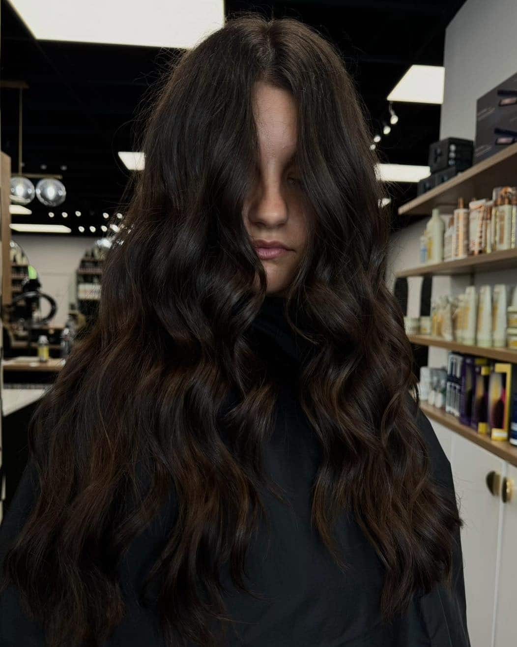 7. Long Curtain-Framed Waves in Deep Brown - Dark Brown Hair Color