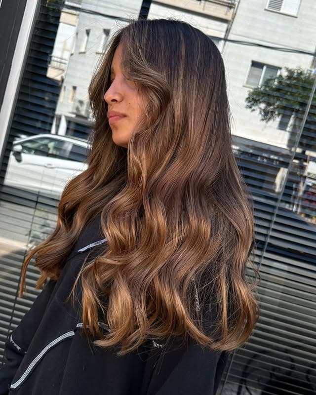 13. Sunlit Caramel Long Layers - Caramel Hair Color