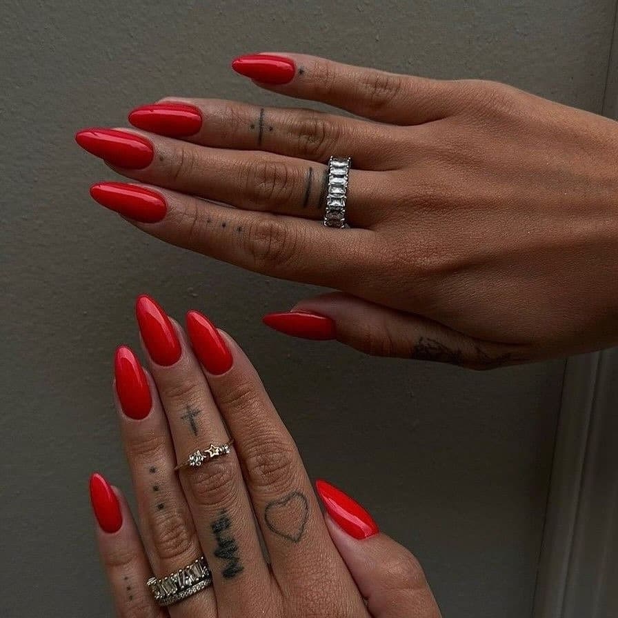 4. Deep Red Almond Nails on Warm Skin - long red nail ideas