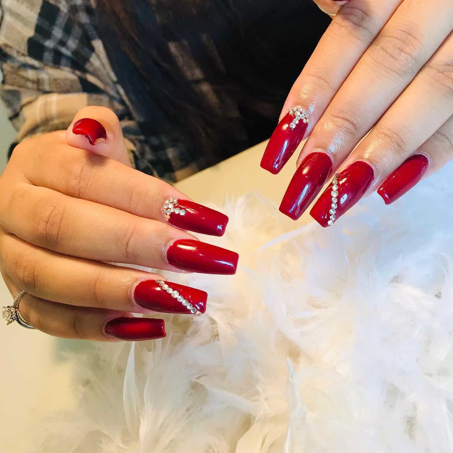9. Red Coffin Nails with Crystal Detail - long red nail ideas