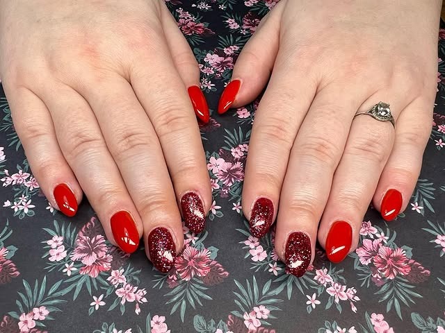 11. Glossy Red Almond Nails with Glitter Accent - long red nail ideas