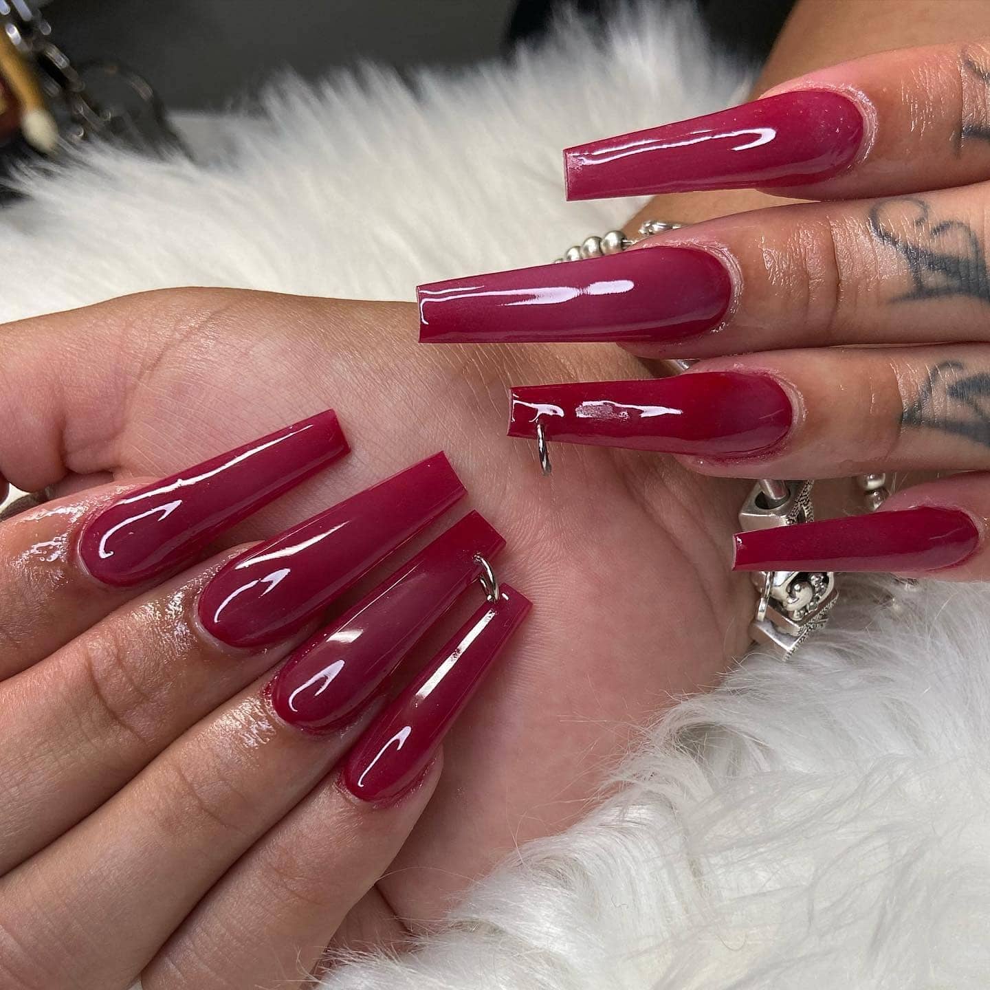 15. Deep Red Coffin Nails with Sleek Finish - long red nail ideas
