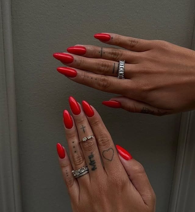 19. Red Almond Nails on Deep Skin Tones - long red nail ideas
