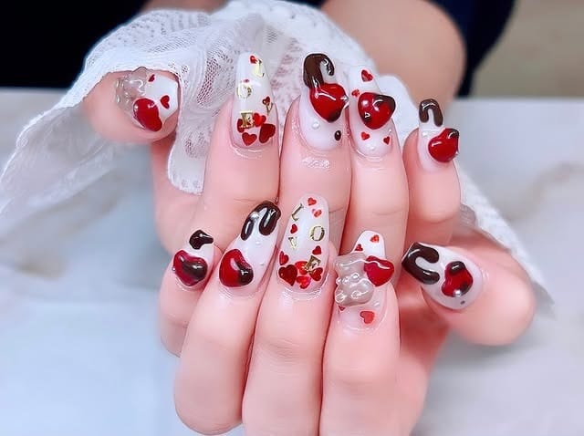 13. Sculpted Almond Nails with Red and Chocolate Heart Art - love nail ideas