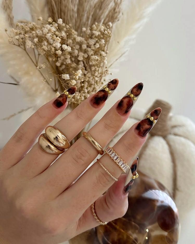 7. Tortoiseshell Almond Luxe with Gold Accents - luxury nail ideas