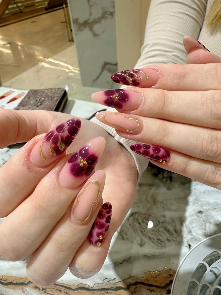 9. Ruby Ombre Almonds with Gold Detailing - luxury nail ideas