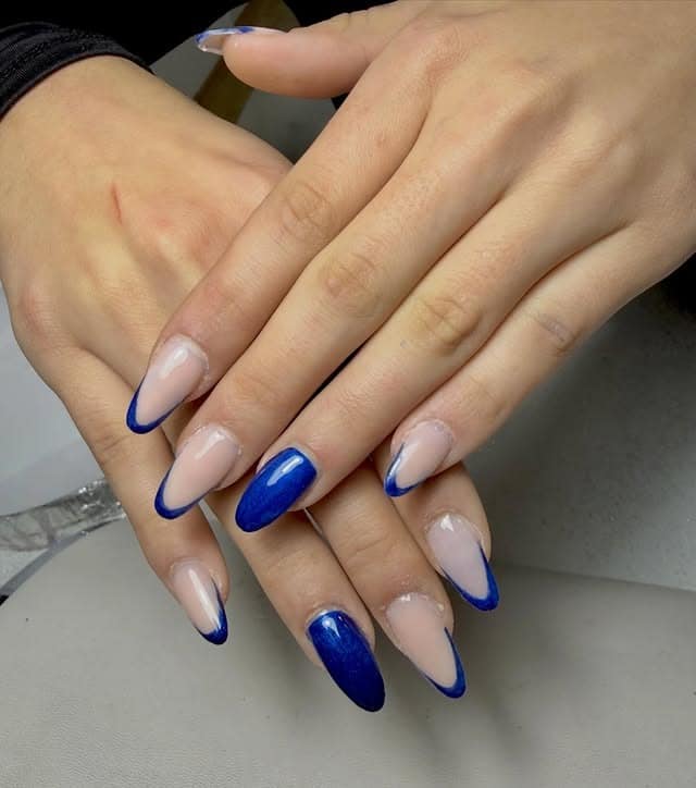 18. Deep Blue Reverse French Almonds - luxury nail ideas