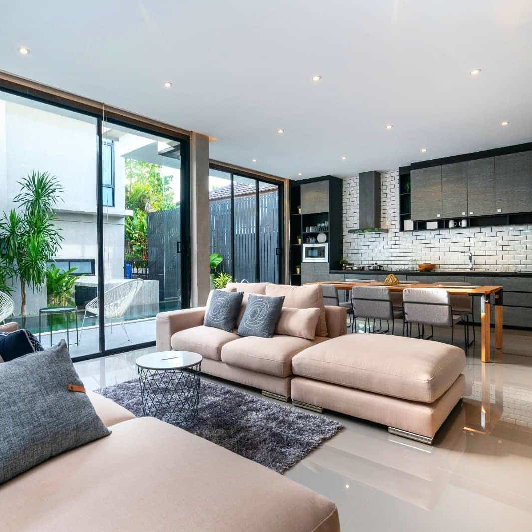 13. Modern Indoor-Outdoor Open Plan with Beige and Charcoal - open kitchen living room ideas