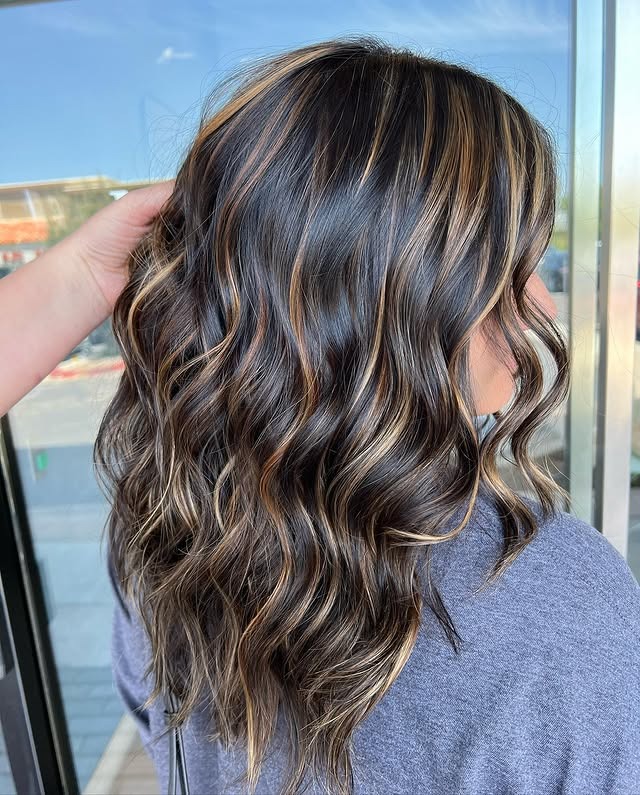 18. Textured Shoulder-Length Waves with Soft Bronze Highlights - Black Hair with Highlights