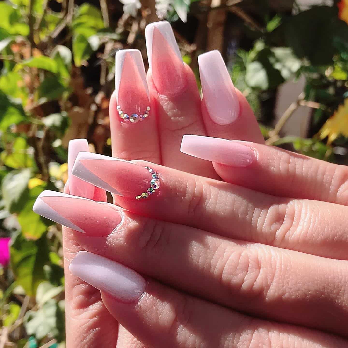 19. Milky Pink Coffin Nails with Crystal Curve - medium length coffin nail ideas