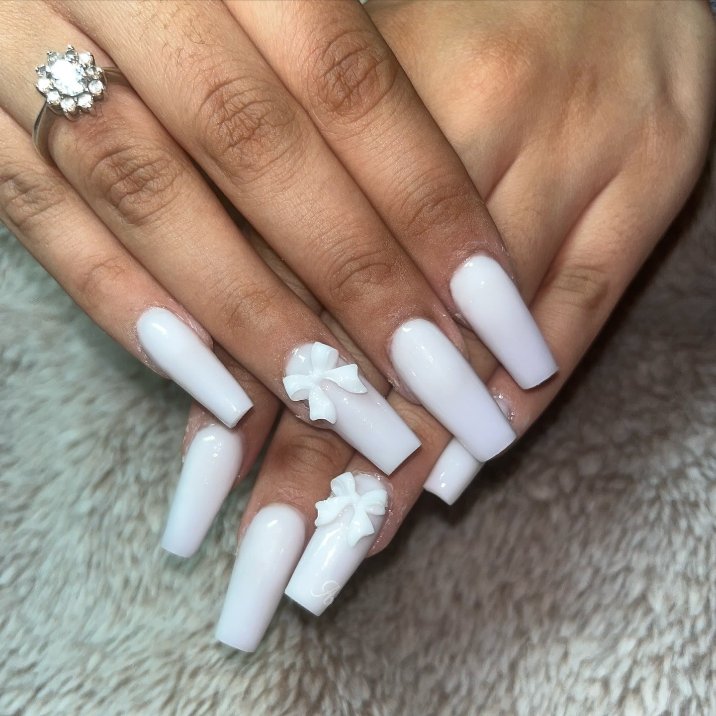 20. Solid White Coffin Nails with Sculpted Bows - medium length coffin nail ideas