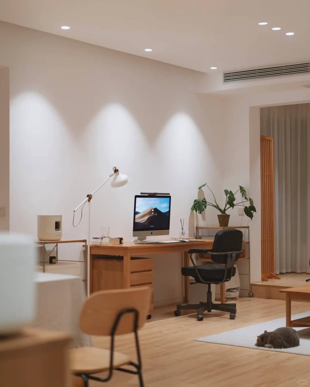 4. Scandinavian-Inspired Living Room Office in Natural Wood and White - living room office ideas