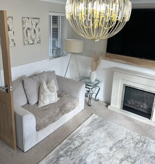 5. Compact Grey Living Room with Refined Gold Lighting - grey and gold living room ideas