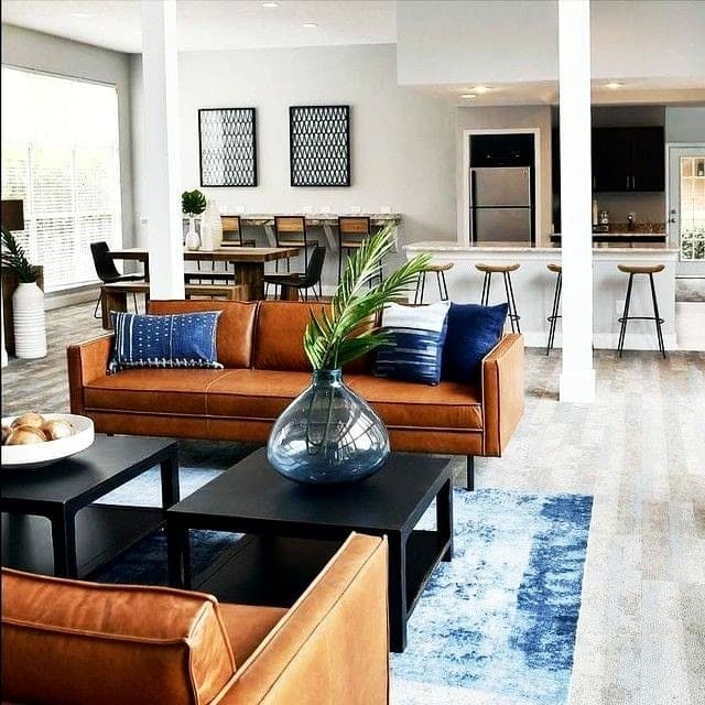 8. Open-Concept Living Space Anchored by Leather - brown leather sofa living room ideas