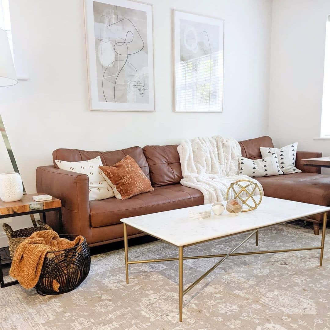 18. Bright Transitional Space with Leather and Brass - brown leather sofa living room ideas
