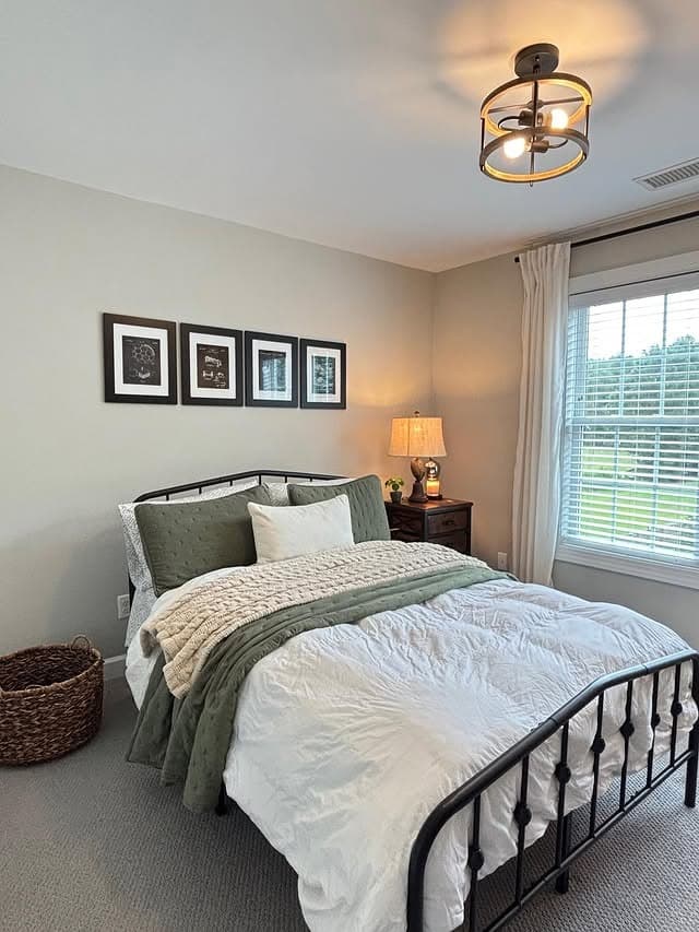 15. Relaxed Traditional Black with Soft Green - metal bed frame bedroom ideas