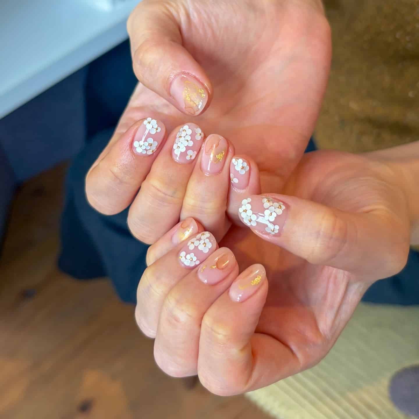 13. Sheer Nude Floral Dot Nails - minimal nail ideas