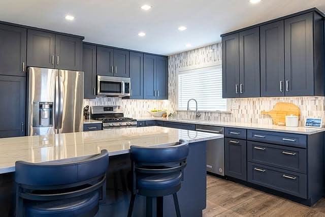1. Deep Navy Shaker Kitchen with Quartz Island - gray and blue kitchen ideas