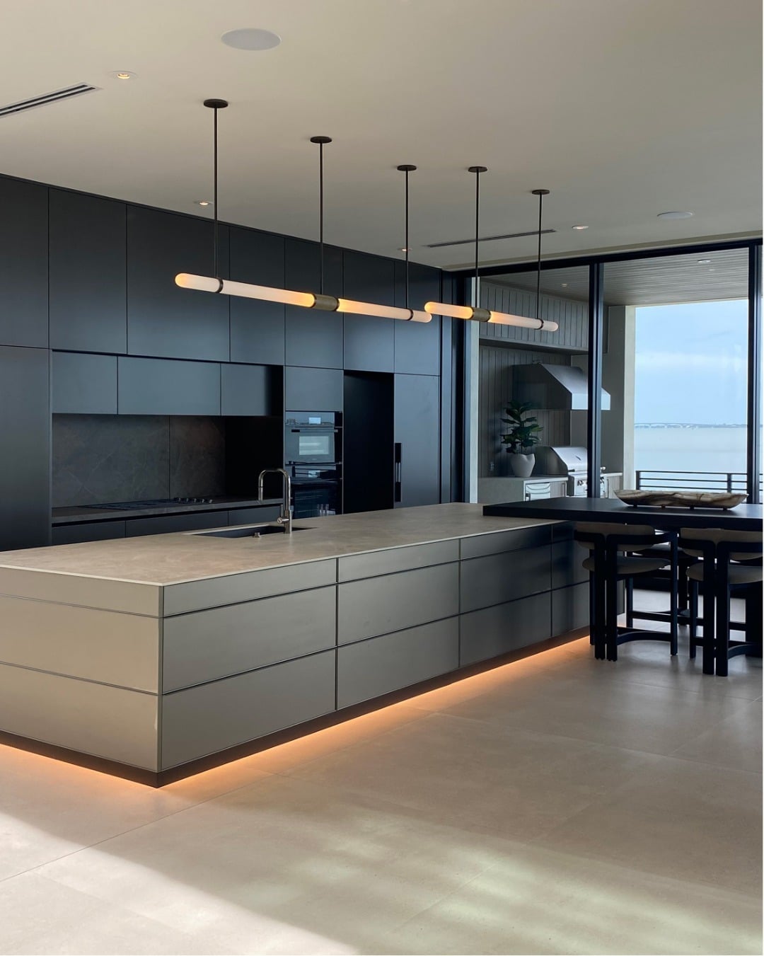 13. Contemporary Blue-Gray Kitchen with Floating Light Effects - gray and blue kitchen ideas