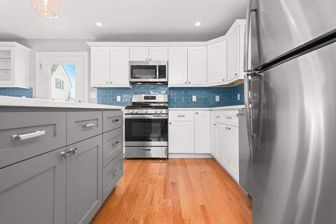 17. White and Gray Kitchen with Blue Glass Tile Detail - gray and blue kitchen ideas