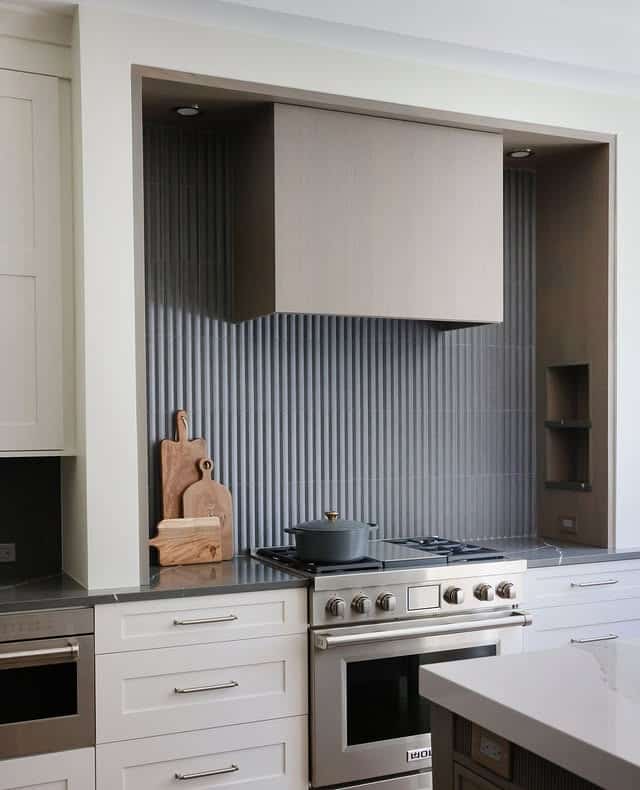 20. Neutral Gray Kitchen with Blue Vertical Tile Feature - gray and blue kitchen ideas