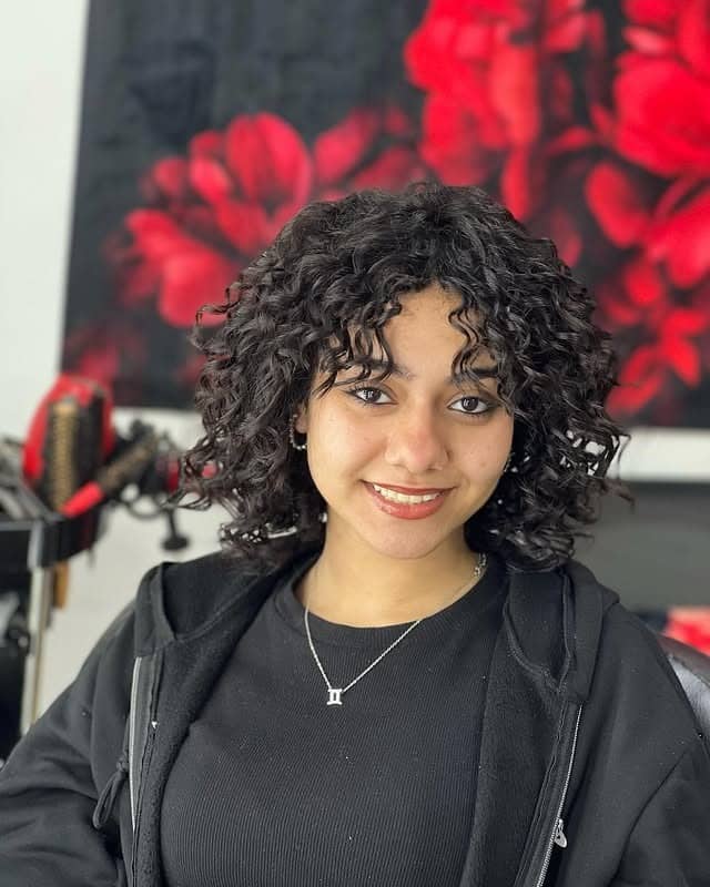 10. Curly Short Bob with Rounded Bangs in Deep Espresso Black - Short Hairstyles with Bangs