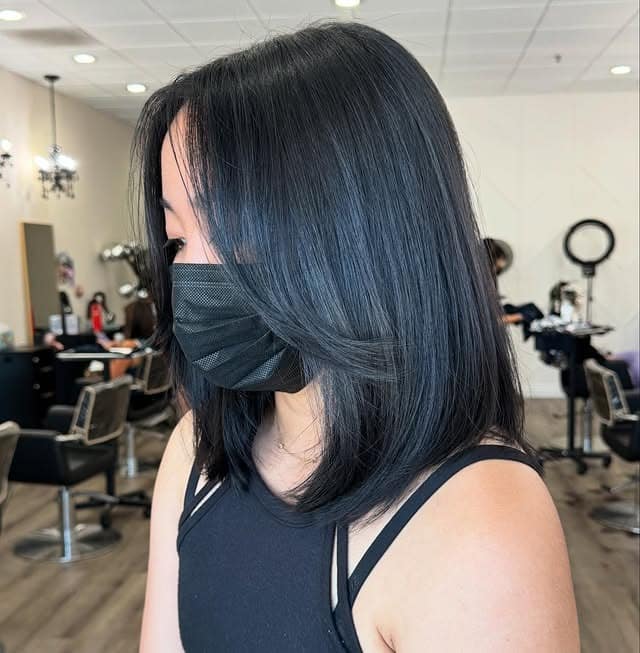 22. Sleek Shoulder-Grazing Bob with Long Bangs in Natural Black - Short Hairstyles with Bangs