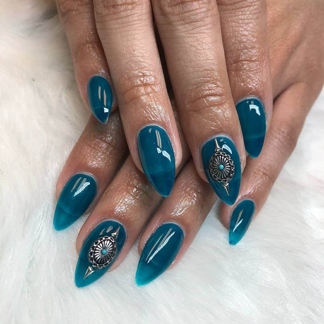 3. Deep Sea Teal Stiletto Nails with Silver Medallions - nautical nail ideas